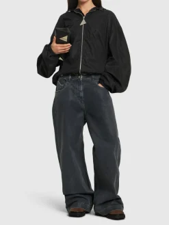 Jeans a gamba larga in tela spalmata